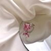 a ring with a heart shaped stone on a mirror